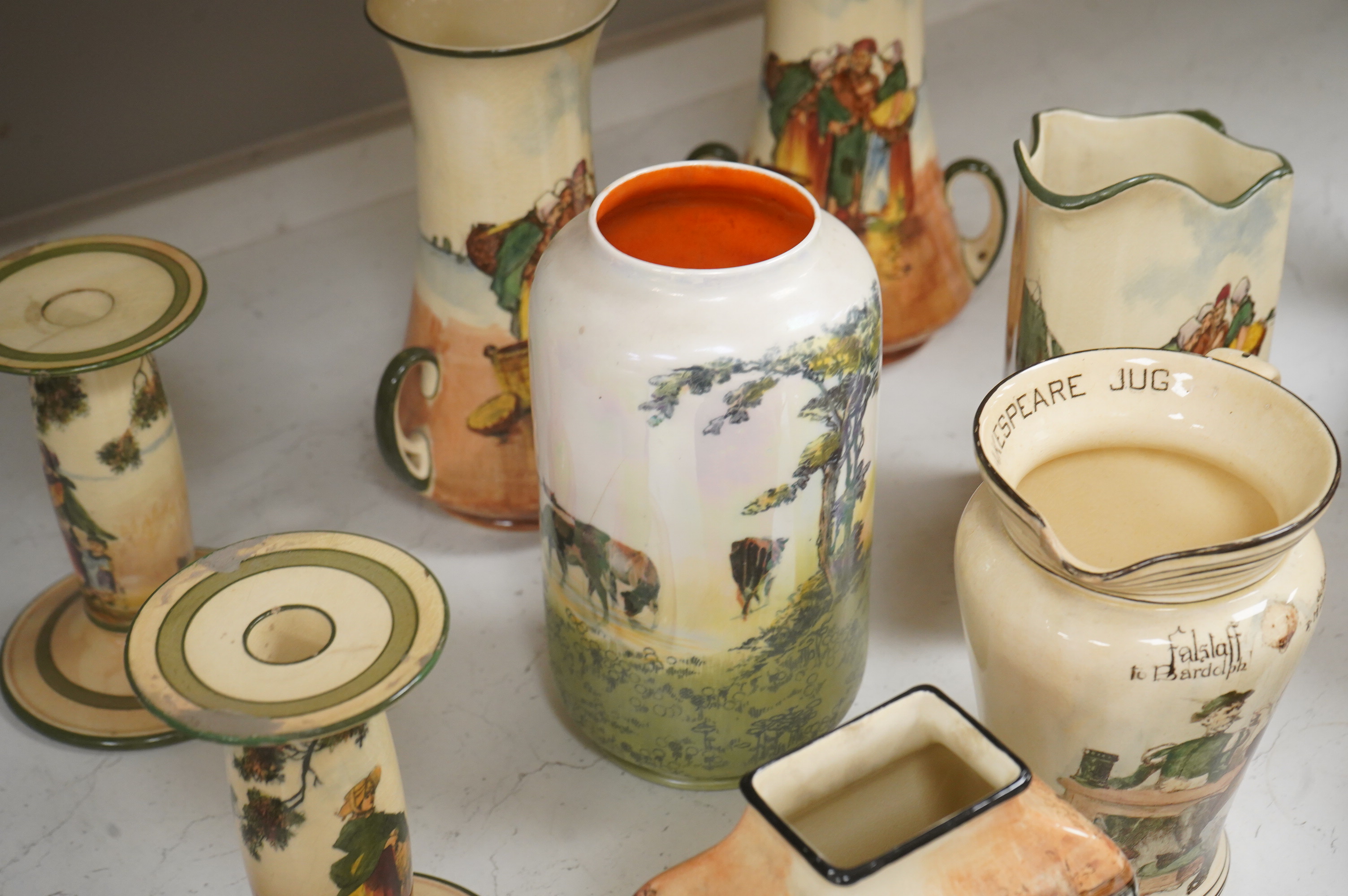 A collection of Royal Doulton series ware jugs, vases and candlesticks, largest 22cm high